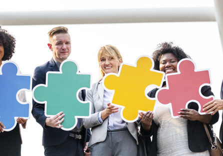 Business people connected by puzzle pieces