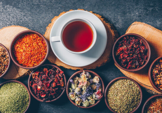 set-wood-stubs-cup-tea-tea-herbs-bowls-dark-textured-background-flat-lay_176474-5213